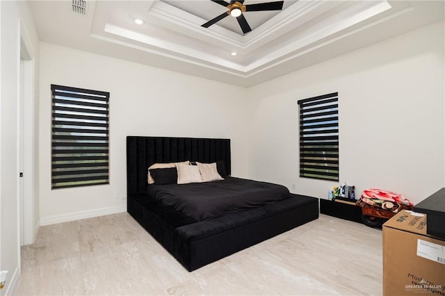 bedroom featuring a tray ceiling, ceiling fan, and hardwood / wood-style flooring