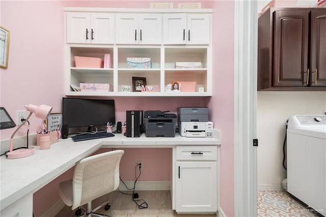 office featuring built in desk and washer / dryer