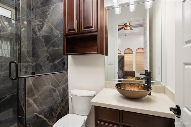 bathroom with vanity, ceiling fan, an enclosed shower, and toilet