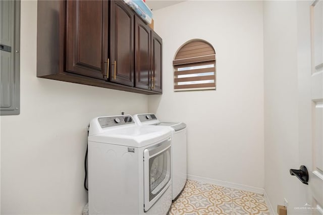 clothes washing area featuring washing machine and clothes dryer and cabinets