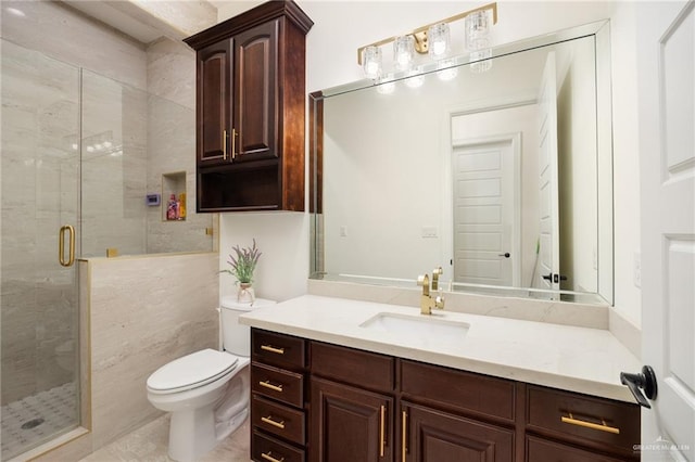 bathroom featuring vanity, toilet, tile walls, and a shower with shower door