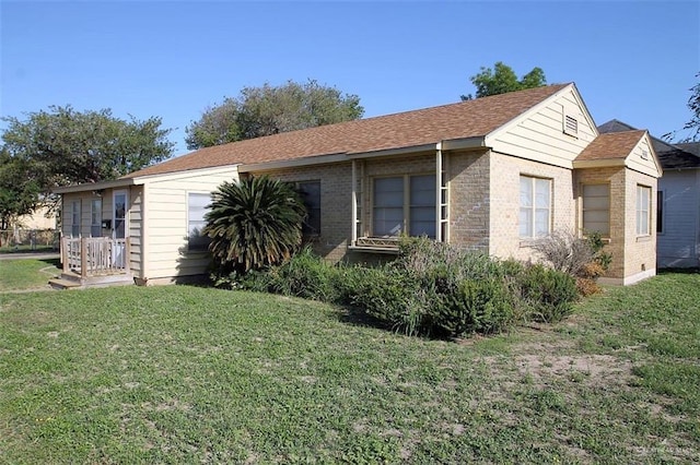 view of home's exterior featuring brick siding and a lawn