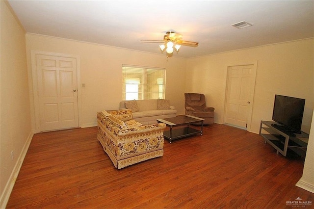 living area featuring visible vents, ceiling fan, baseboards, and wood finished floors