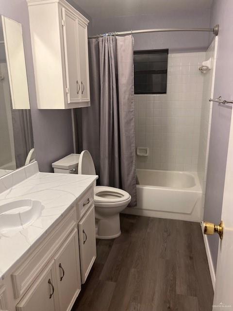 full bathroom featuring shower / bathtub combination with curtain, vanity, toilet, and wood-type flooring