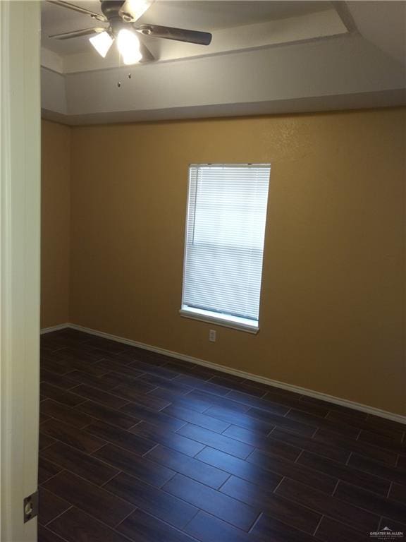 unfurnished room featuring a tray ceiling and ceiling fan