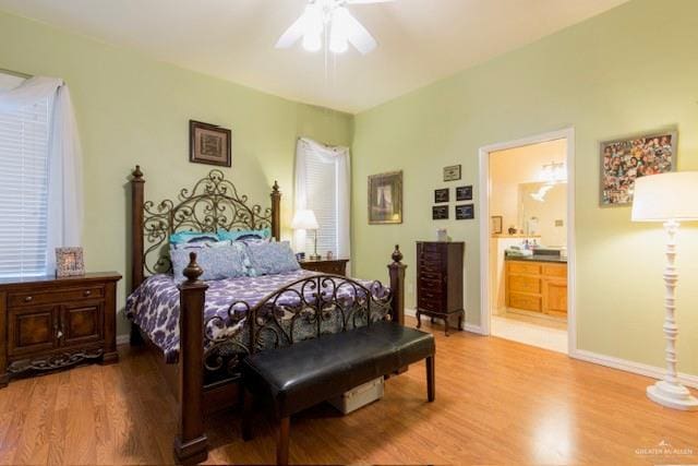 bedroom with hardwood / wood-style flooring, ceiling fan, and connected bathroom