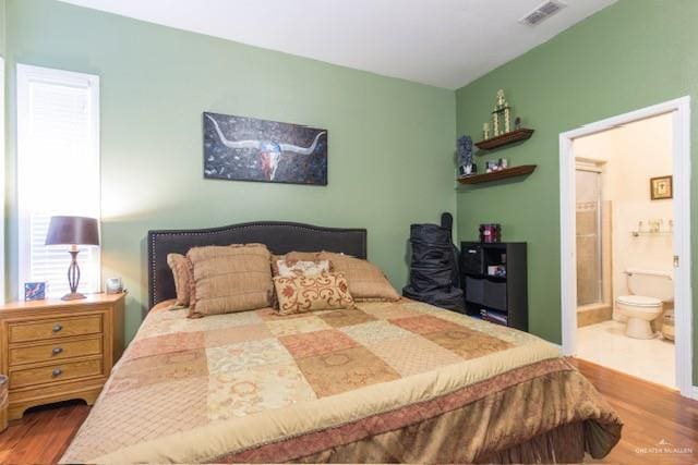 bedroom featuring wood-type flooring and connected bathroom