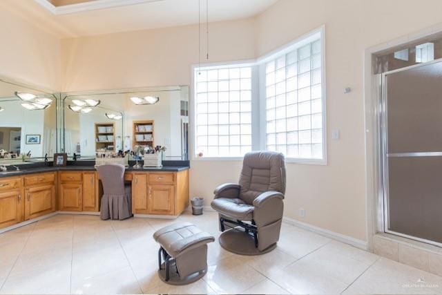 bathroom with tile patterned floors, vanity, and an enclosed shower