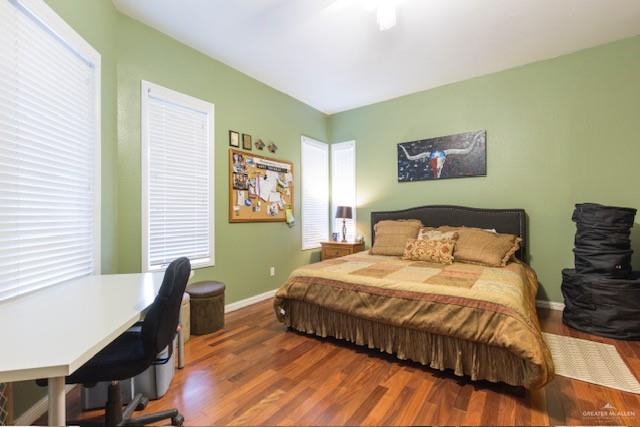 bedroom with dark hardwood / wood-style floors