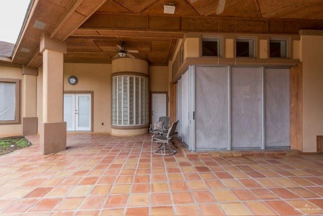 doorway to property with ceiling fan and a patio area