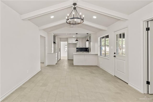 kitchen featuring white cabinets, vaulted ceiling with beams, decorative light fixtures, and a chandelier