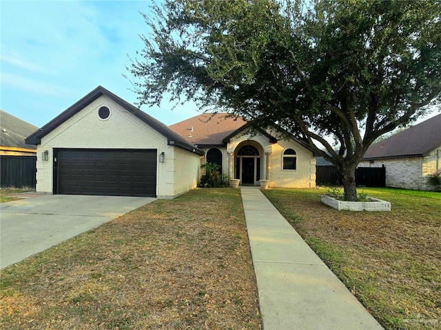 1511 Oak Dr, Mission, TX 78572 - view of front facade featuring an attached garage, concrete driveway, and brick siding