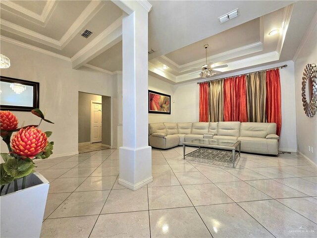 1511 Oak Dr, Mission, TX 78572 - living room with ornamental molding, a tray ceiling, light tile patterned flooring, baseboards, and ornate columns