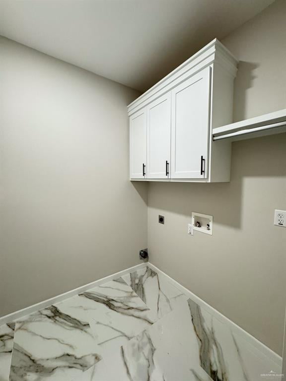 laundry area with electric dryer hookup, washer hookup, and cabinets