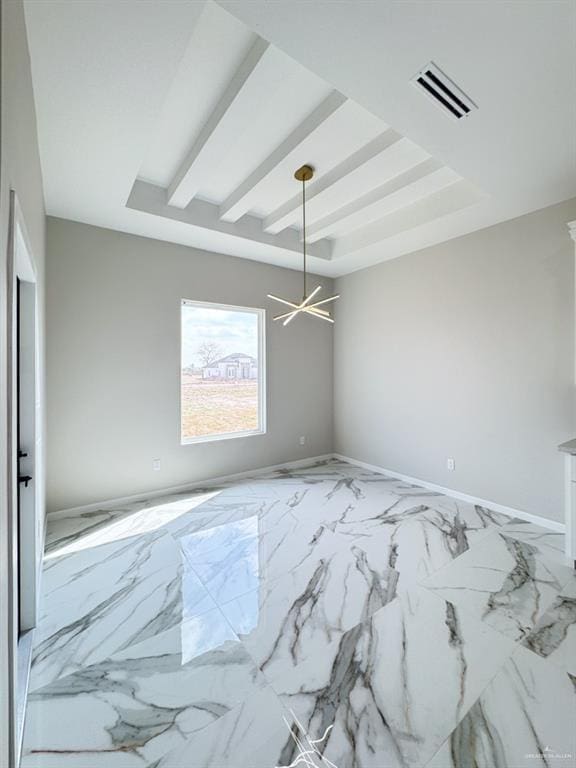 spare room with beamed ceiling and a tray ceiling