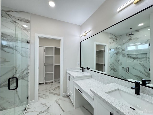 bathroom with vanity and a shower with shower door