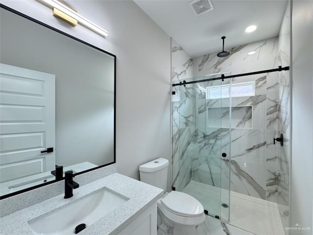 bathroom featuring vanity, toilet, and an enclosed shower