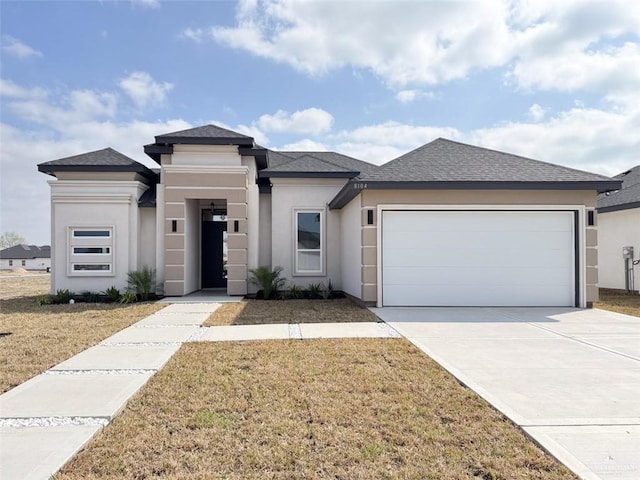 prairie-style home with a garage and a front yard