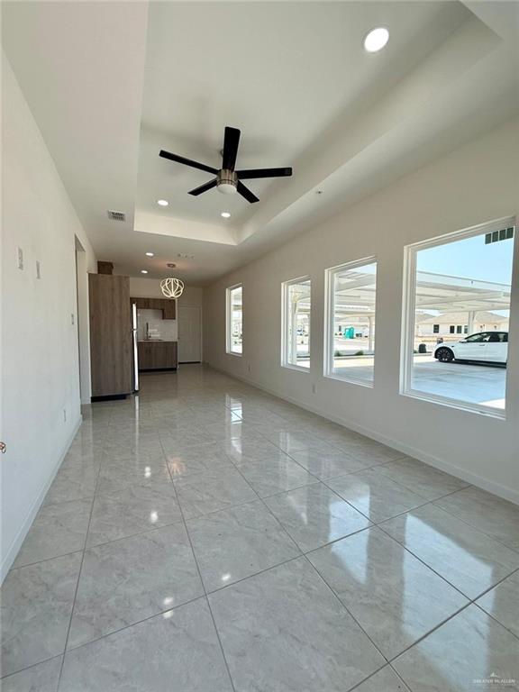 5325 Vision St, Rio Grande City, TX 78582 - unfurnished room with a raised ceiling, baseboards, recessed lighting, and ceiling fan