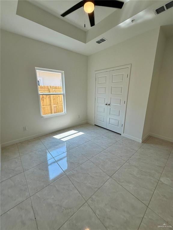5325 Vision St, Rio Grande City, TX 78582 - unfurnished bedroom with a raised ceiling, light tile patterned flooring, baseboards, and a closet