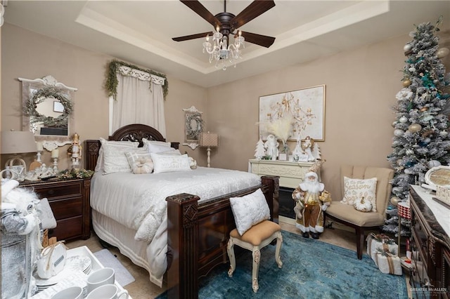 bedroom featuring light carpet, a raised ceiling, and ceiling fan