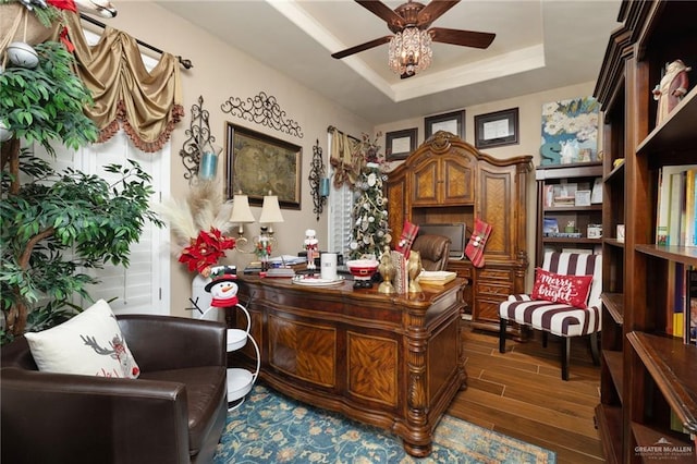 office area featuring a raised ceiling, ceiling fan, and dark hardwood / wood-style floors