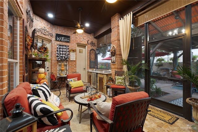 wine cellar with ceiling fan, plenty of natural light, and brick wall