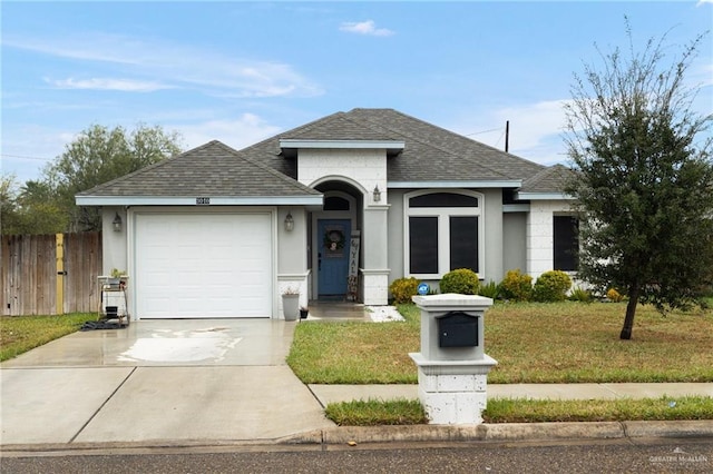 ranch-style house with a garage and a front lawn