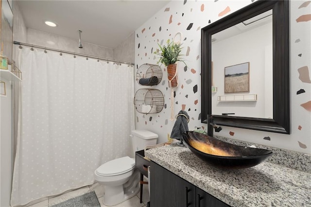 bathroom featuring toilet, vanity, and tile patterned flooring