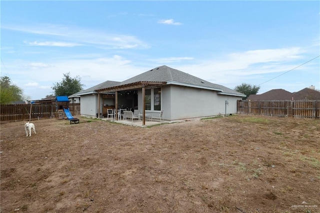 back of property with a playground and a patio area