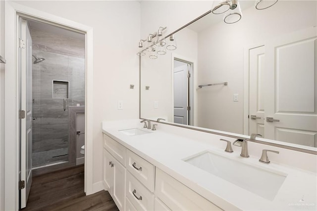 2508 E Solar Dr, Mission, TX 78501 - full bath featuring double vanity, a shower stall, toilet, and wood finished floors