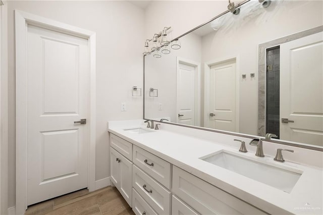 2508 E Solar Dr, Mission, TX 78501 - full bathroom featuring double vanity, wood finished floors, and baseboards