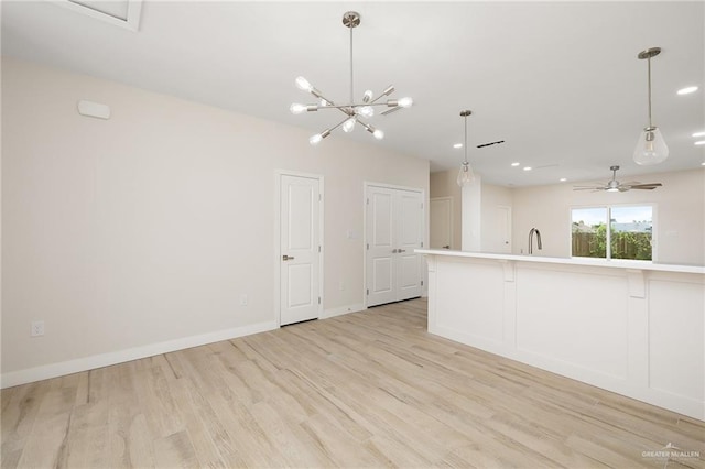 2508 E Solar Dr, Mission, TX 78501 - unfurnished living room with light wood-type flooring, a sink, recessed lighting, baseboards, and a ceiling fan
