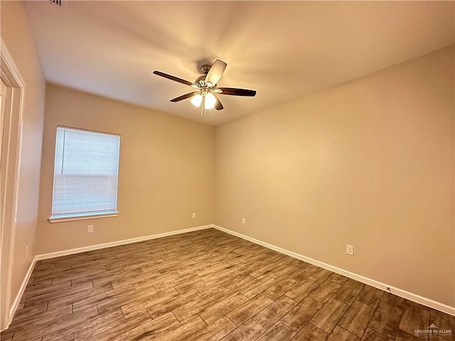 spare room featuring wood-type flooring and ceiling fan