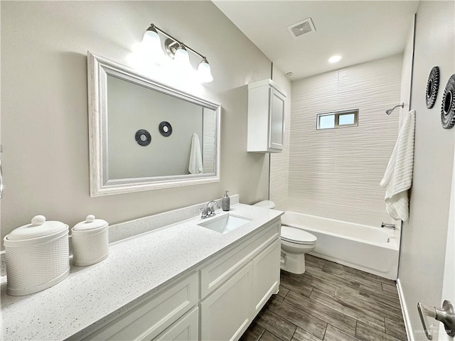 full bathroom featuring vanity, bathing tub / shower combination, and toilet