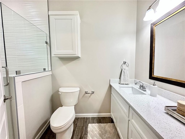 bathroom with vanity, hardwood / wood-style floors, and toilet