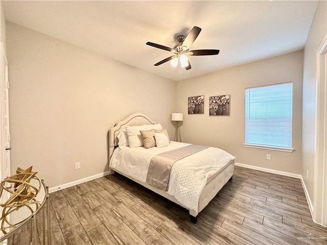 bedroom with wood-type flooring and ceiling fan