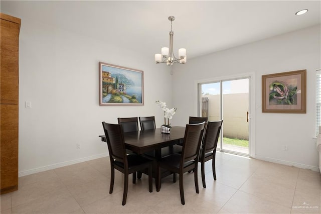 tiled dining room with a notable chandelier