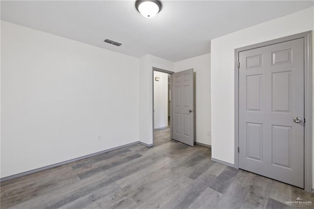609 E Sprague St, Edinburg, TX 78539 - unfurnished bedroom featuring wood finished floors and baseboards