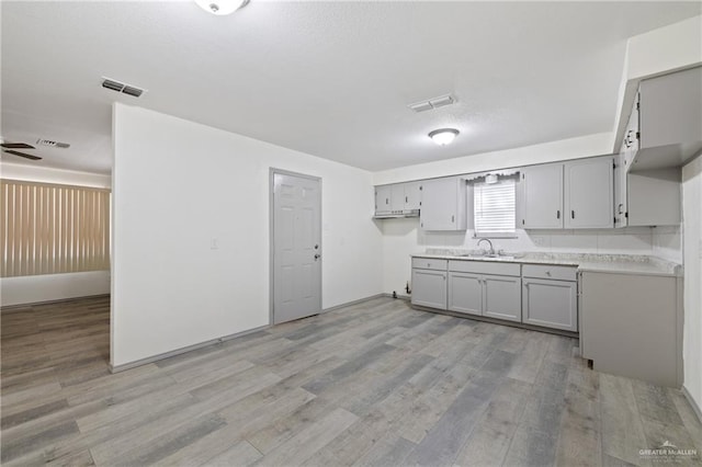 609 E Sprague St, Edinburg, TX 78539 - kitchen featuring gray cabinets, light wood-style flooring, light countertops, and ceiling fan
