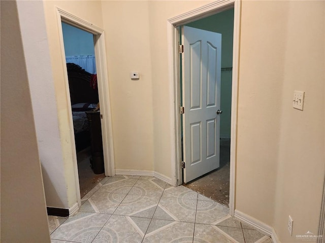 corridor with light tile patterned flooring