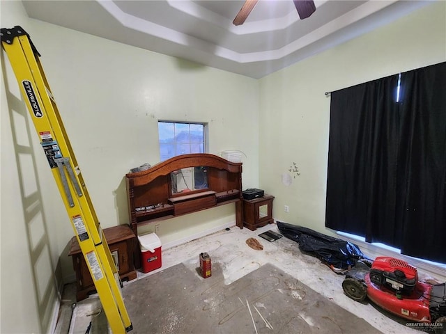 bedroom with a tray ceiling and ceiling fan