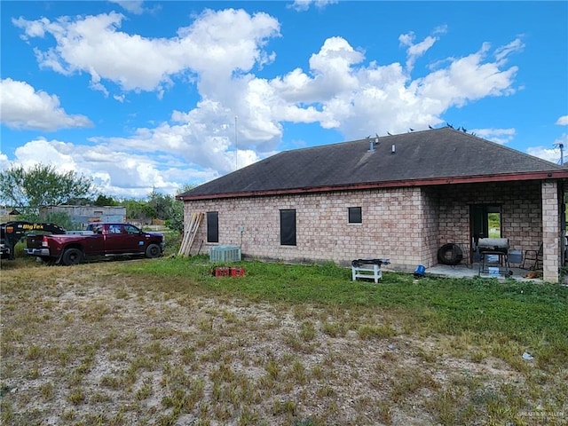 back of house with a patio and central AC unit