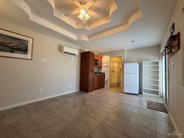 3810 Pelican Way, Mission, TX 78572 - unfurnished living room featuring baseboards, an AC wall unit, a raised ceiling, and a ceiling fan