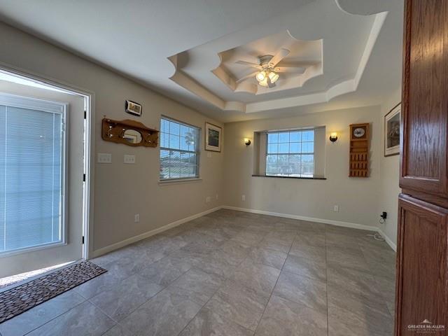 3810 Pelican Way, Mission, TX 78572 - foyer with a tray ceiling, plenty of natural light, baseboards, and ceiling fan