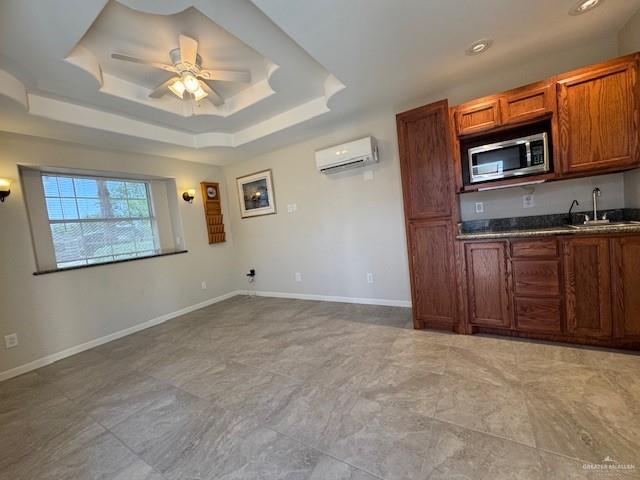 3810 Pelican Way, Mission, TX 78572 - kitchen with a wall mounted air conditioner, a ceiling fan, a sink, stainless steel microwave, and a raised ceiling