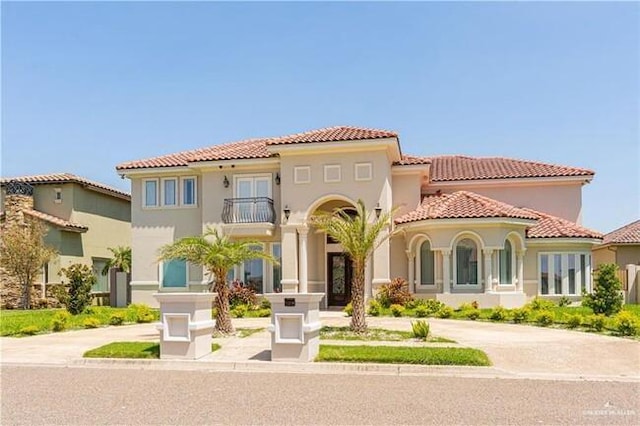 mediterranean / spanish-style house featuring a balcony