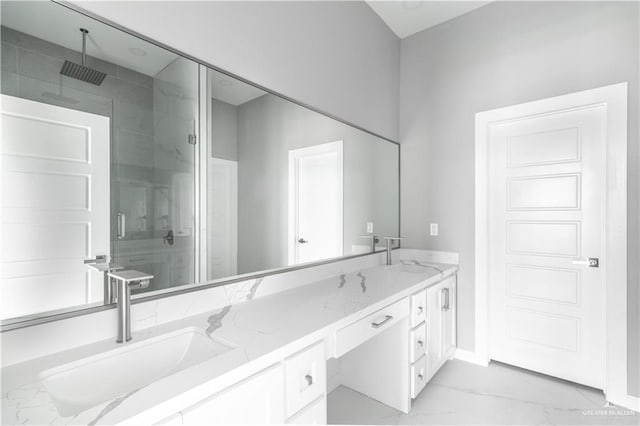 bathroom with marble finish floor, a sink, a shower stall, and double vanity