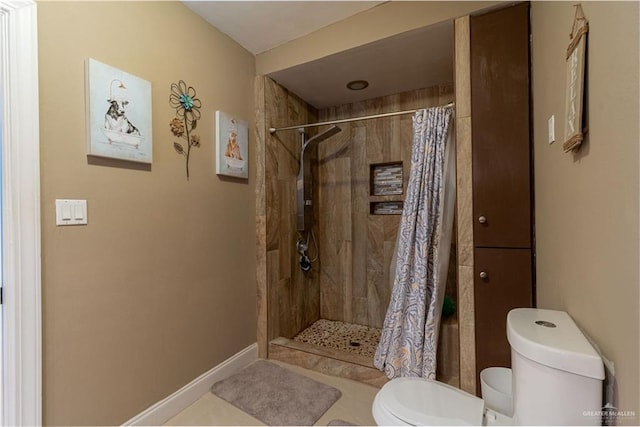 bathroom with tile patterned flooring and toilet