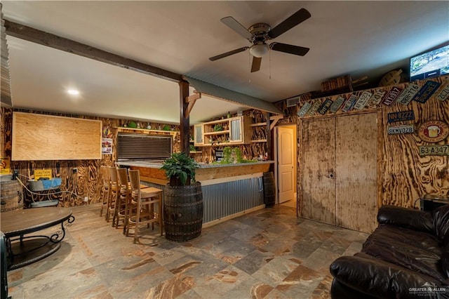 bar featuring beamed ceiling and ceiling fan